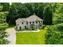 Beautiful aerial view of the property with a large, green lawn and mature trees at 5055 Turkey Track Rd, Martinsville, IN 46151