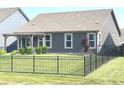 The property boasts a spacious, fully fenced backyard with a young tree, and a cozy covered patio at 5103 Covington Ave, McCordsville, IN 46055