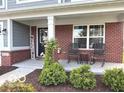 Charming covered porch with rocking chairs and a welcoming 'Welcome' sign at 520 Ferndale Ln, Danville, IN 46122