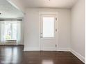 Bright entryway with hardwood floors, featuring a stylish door and a glimpse of the living area at 525 Orange St, Indianapolis, IN 46203