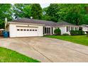 Inviting single-story home features a driveway and an attached two-car garage at 535 Radburn Dr, Indianapolis, IN 46214