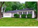 Well-maintained single-story home with lush green lawn and an attached two-car garage at 535 Radburn Dr, Indianapolis, IN 46214