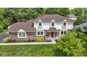 Beautiful two-story home featuring brick and siding, a well-kept lawn, and a tidy landscape at 59 Sycamore Dr, Carmel, IN 46033