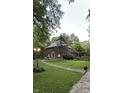 Charming brick home with mature landscaping and pathway to front door at 6125 N Olney St, Indianapolis, IN 46220