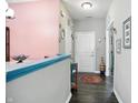 Hallway with modern lighting, neutral paint, and hardwood floors that add a touch of sophistication at 6315 Emerald Field Way, Indianapolis, IN 46221