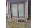 Brick back patio features sliding glass doors and a small welcome mat at 721 Maplewood Ave, Anderson, IN 46012