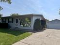 Charming single-story home featuring a well-maintained lawn and convenient detached garage at 737 Howard St, Shelbyville, IN 46176