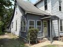 A charming, two-story home with a covered entryway and mature trees in the front yard at 807 N Elm St, Muncie, IN 47305