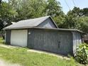 A detached garage with both sliding and swing out doors, offering ample storage space at 807 N Elm St, Muncie, IN 47305