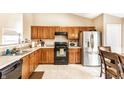 Bright kitchen features oak cabinets, stainless steel appliances, and ample countertop space at 8116 Harshaw Dr, Indianapolis, IN 46239