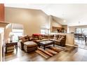 Open living room with a vaulted ceiling, hardwood floors, and a large sofa perfect for Gathering time at 8116 Harshaw Dr, Indianapolis, IN 46239
