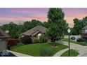 Beautiful brick home with mature trees and a lush green lawn at 8144 Grassy Meadow Cir, Indianapolis, IN 46259