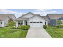 Attractive single-story home with a lush front yard and a white two-car garage at 820 Elise Dr, Westfield, IN 46074