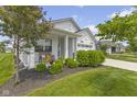 A well-manicured yard with bench seating near the front porch and a single-story home in the background at 820 Elise Dr, Westfield, IN 46074
