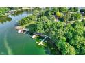 Scenic aerial shot of waterfront property with docks and lush greenery surrounding the serene lake at 8261 Twin Pointe Cir, Indianapolis, IN 46236