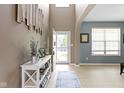 Inviting entryway features light hardwood floors, stylish decor, and an open doorway, creating a welcoming first impression at 8720 N Deer Crossing Blvd, McCordsville, IN 46055