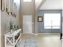 Welcoming entryway featuring light hardwood floors, neutral walls, and stylish decor, complemented by an archway and natural light at 8720 N Deer Crossing Blvd, McCordsville, IN 46055