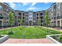 Lovely courtyard featuring well-manicured lawns, benches and walkways surrounded by apartment buildings at 920 Veterans Way # 204, Carmel, IN 46032