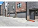 Attached garages for townhomes with address signage, providing convenient parking and street access at 920 Veterans Way # 204, Carmel, IN 46032