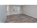 Bright bedroom with neutral walls, wood-look floors, and a large window for natural light at 10420 Day Star Dr, Indianapolis, IN 46234