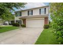 Well-maintained two-story home with a spacious driveway, two-car garage, and manicured landscaping at 10420 Day Star Dr, Indianapolis, IN 46234