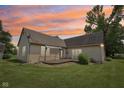 Exterior backyard showcasing the deck, lush green lawn, and the overall tranquility of outdoor living at 10444 Indian Lake N Blvd, Indianapolis, IN 46236