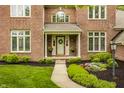 Inviting front porch with a wreath and flower pots adding charm to this well-maintained home at 11875 Durbin Dr, Carmel, IN 46032