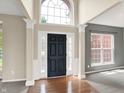 Inviting entryway with hardwood floors, grand pillars and a striking black door flanked by sidelights at 12635 Tuscany Blvd, Carmel, IN 46032
