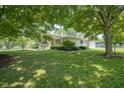 Expansive lawn with mature trees offering ample shade, providing a serene outdoor setting at 1524 Northcrest Dr, Anderson, IN 46012