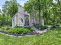 Charming two-story home with landscaped yard and a beautiful porch, perfect for relaxing outdoors at 17320 Joliet Rd, Westfield, IN 46074