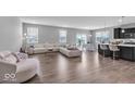 Spacious living room featuring contemporary furniture and an open layout concept to the kitchen and dining areas at 1758 Pelham Dr, Greenwood, IN 46143