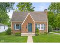 Charming brick home featuring a well-manicured lawn, complemented by vibrant landscaping and inviting curb appeal at 1944 Union St, Columbus, IN 47201