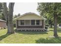 Charming home showcasing a screened-in porch with brick facade and mature trees at 2245 N Ritter Ave, Indianapolis, IN 46218