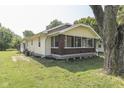 Quaint home featuring a screened-in porch, cream siding and a detached garage at 2245 N Ritter Ave, Indianapolis, IN 46218
