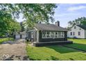 Charming home featuring a well-maintained lawn, detached garage, and classic architectural details at 2719 Denison St, Indianapolis, IN 46241