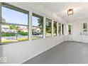 Bright sunroom featuring large windows offering plenty of natural light and views of the neighborhood at 2719 Denison St, Indianapolis, IN 46241