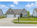 Charming home features a landscaped yard, three car garage and inviting curb appeal at 3839 Albert Ln, Bargersville, IN 46106