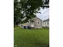View of the back of the house with lawn and trees at 4715 Normal Ave, Indianapolis, IN 46226