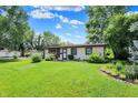 Well-maintained home with a lush green lawn, garden, and mature trees at 4770 Willow Rd, Zionsville, IN 46077