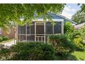 An inviting screened in porch with greenery enhancing its appeal to relax in the comfort of your home at 5126 Hillside Ave, Indianapolis, IN 46205