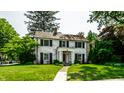 Attractive two-story home boasting a lush green lawn, a welcoming walkway, and beautiful greenery at 5261 N Pennsylvania St, Indianapolis, IN 46220