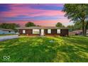 Charming brick home with a well-manicured lawn and lovely landscaping at 608 W 600 N, Fortville, IN 46040