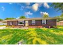 Inviting single-story brick home featuring neat landscaping and a bright front door at 608 W 600 N, Fortville, IN 46040