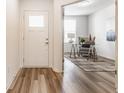Bright foyer with hardwood floors, leading to a home office with modern furnishings at 6537 Seabiscuit Rd, Whitestown, IN 46075