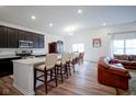 Bright, open-concept kitchen featuring a large island with seating and modern appliances at 6608 W Shoreline Ct, Greenfield, IN 46140
