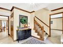 Welcoming foyer with a staircase, decorative mirror, and neutral color scheme at 664 N Scott Dr, Greenwood, IN 46142
