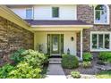 Inviting front entrance with a green door, sidelights, and decorative landscaping at 664 N Scott Dr, Greenwood, IN 46142