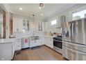 Well-appointed kitchen featuring white cabinets, subway tile backsplash, and stainless steel appliances at 712 Orange St, Indianapolis, IN 46203