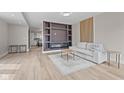 Modern living room features a stylish fireplace, elegant light wood floors, and a comfortable couch at 714 S Keystone Ave, Indianapolis, IN 46203