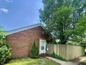 Charming single-Gathering home with brick facade and well-maintained front yard with mature trees at 7392 S Meridian St, Indianapolis, IN 46217